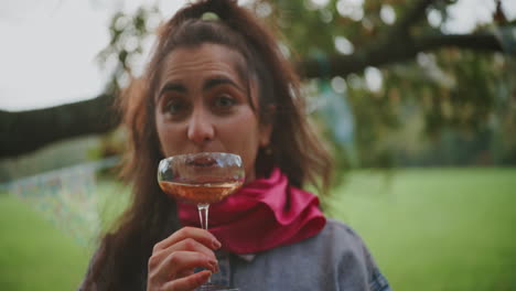woman enjoying a rose wine in a garden