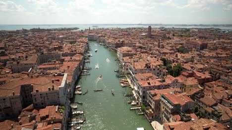 aerial drone fly above grand canal of venice italy, water channel, gondolas, cityscape architecture during summer daytime in italian touristic destination