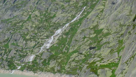 water flowing down rocky mountains in switzerland