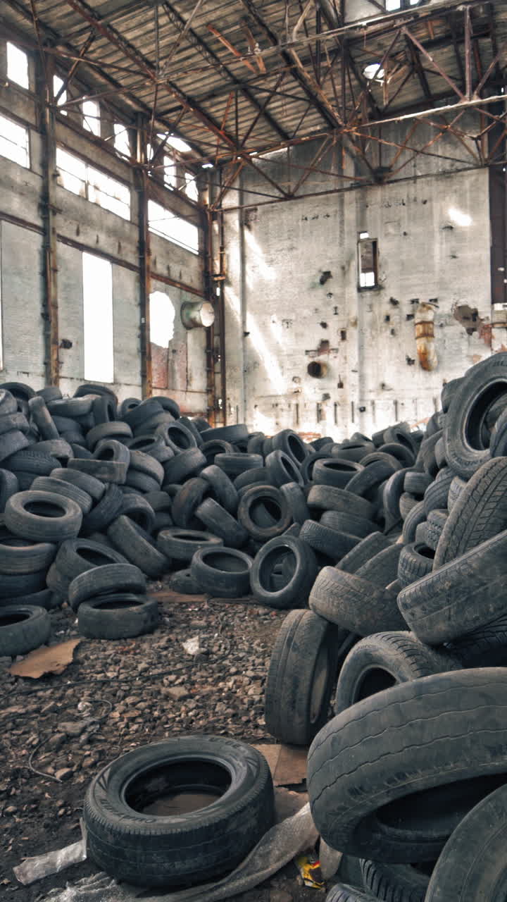 Old damaged tires after driving. Stack of car second used car rubber tires Vertical video