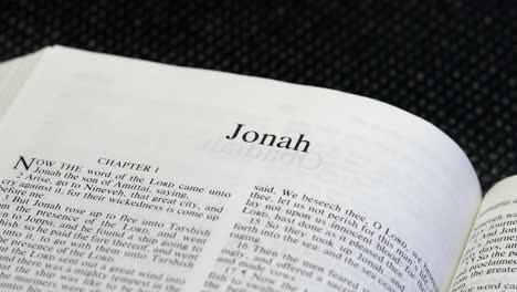 close up shot of bible page turning to the book of jonah