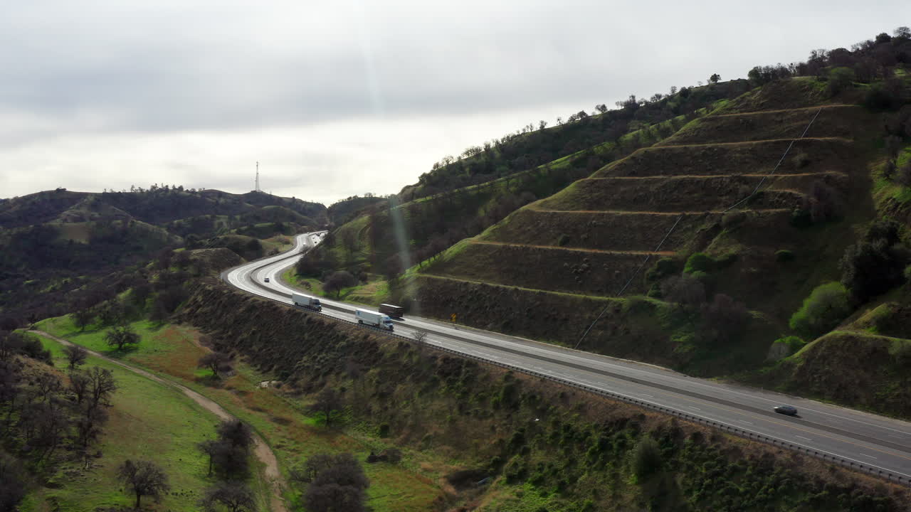 Trucks driving along highway in the hills of Tehachapi California