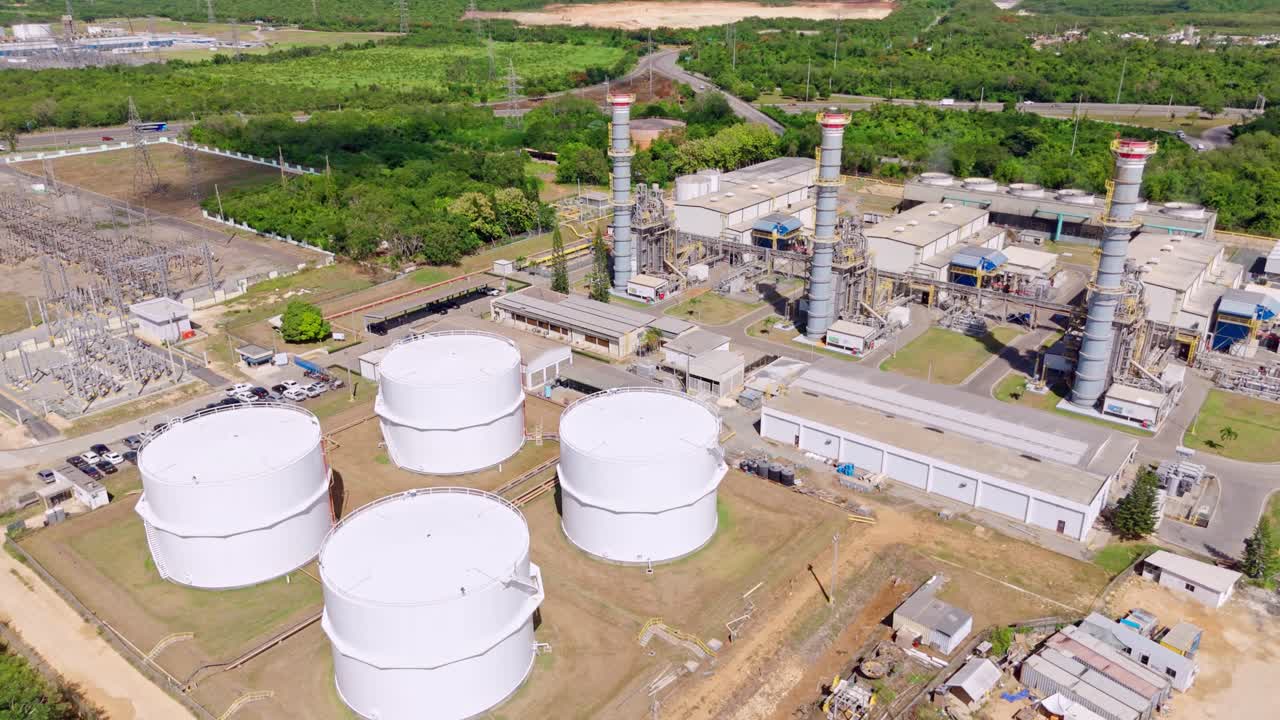Aerial drone view of fuel storage tanks and exhaust towers at Energas 4 plant, Dominican Republic