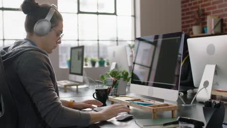 young caucasian man programmer coding network security software for startup company professional web developer typing code on computer screen writing notes listening to music in office