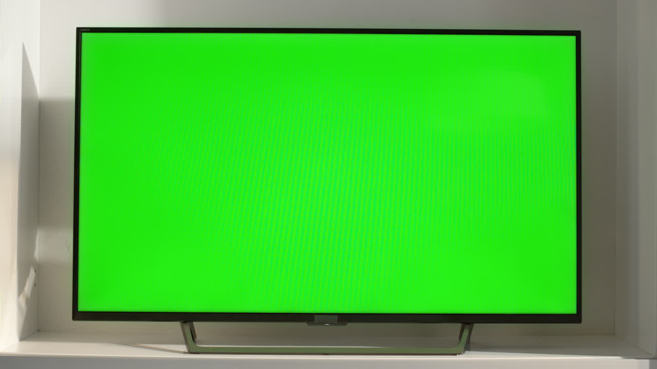 Chroma key smart TV in living room closeup. Device with blank screen in sunlight