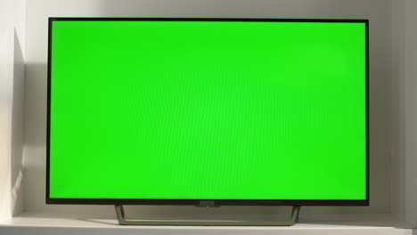 chroma key smart tv in living room closeup. device with blank screen in sunlight