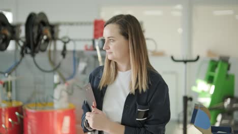 female manager discussing vehicle repair with mechanic in auto repair shop