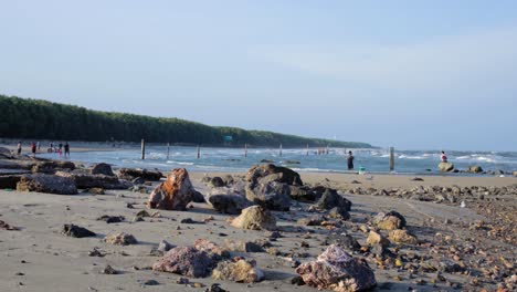 rocky beach panning up reveal ocean shoreline in thailand