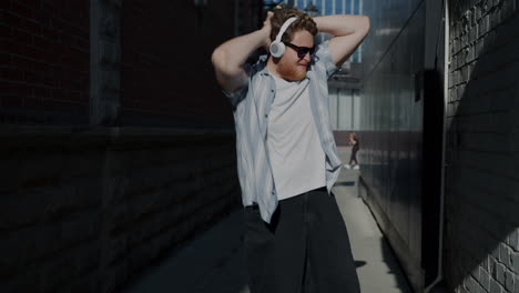 man dancing in an alley with headphones
