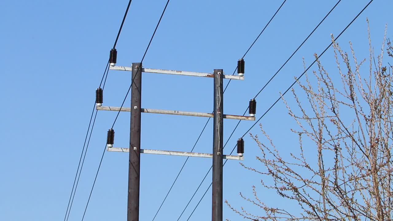 Power lines against a blue sky. Spring. UK