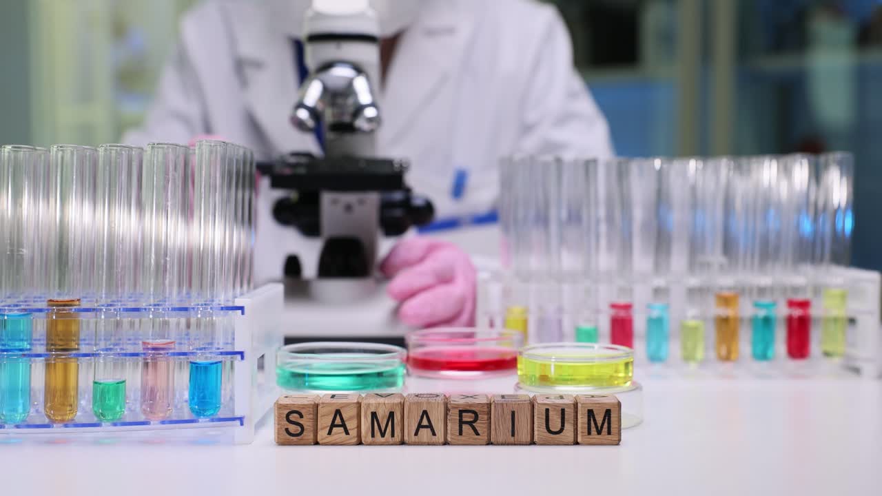 Scientist working in a laboratory with chemicals and equipment, focusing on 'Samarium'