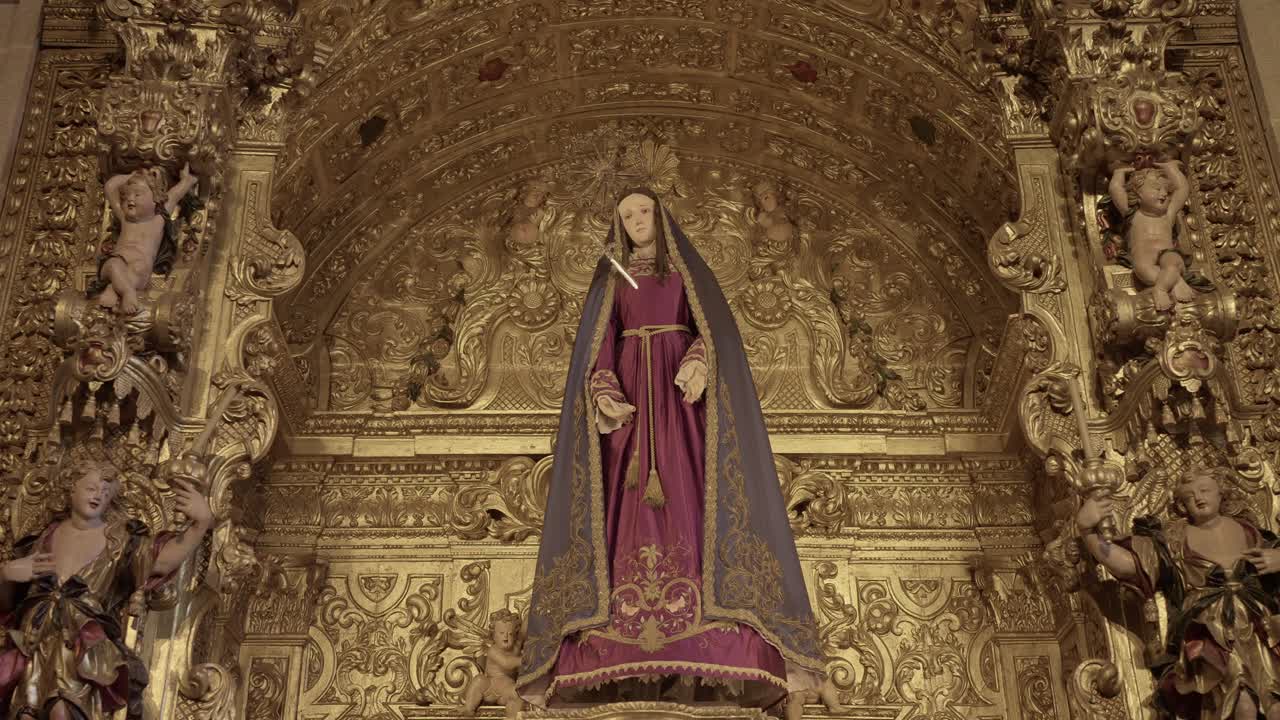 richly decorated religious statue of the Virgin Mary in a golden altar with intricate details
