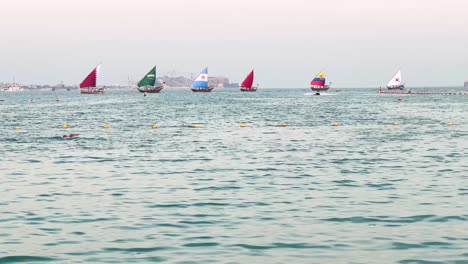 qatar morocco argentina ecuador korea saudi arabia with al nassr in football asia in a frame of traditional boat sailing in the sea a man is swimming in the scene scenic background of sunset and tower