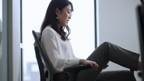 a reflective moment in the office: a professional woman engaged in thought, captured between two frames of productive reflection and quiet contemplation