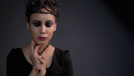 Young-beautiful-girl-posing-in-front-of-the-camera-Her-hair-is-in-the-form-metal-jewelry