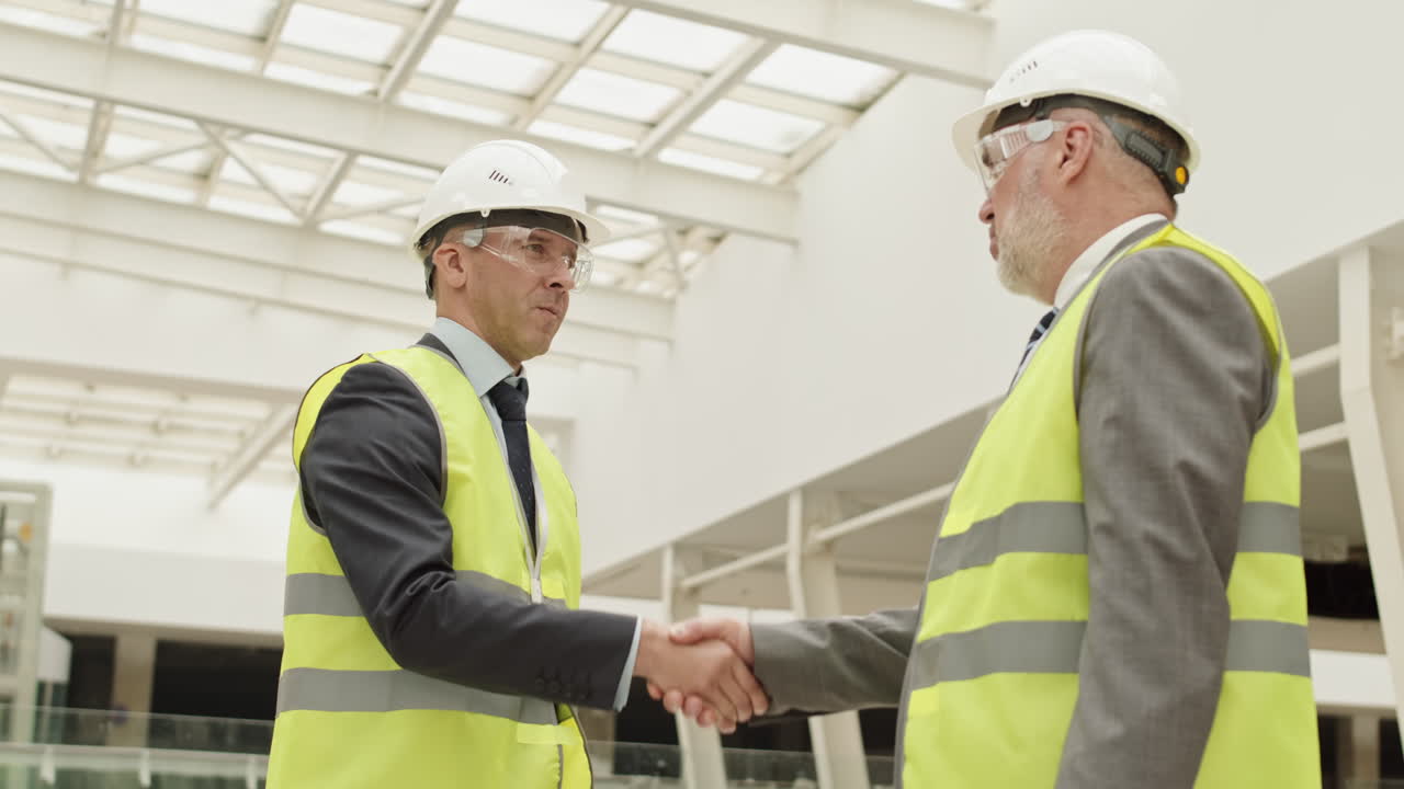 Professional Builders Shaking Hands at Work