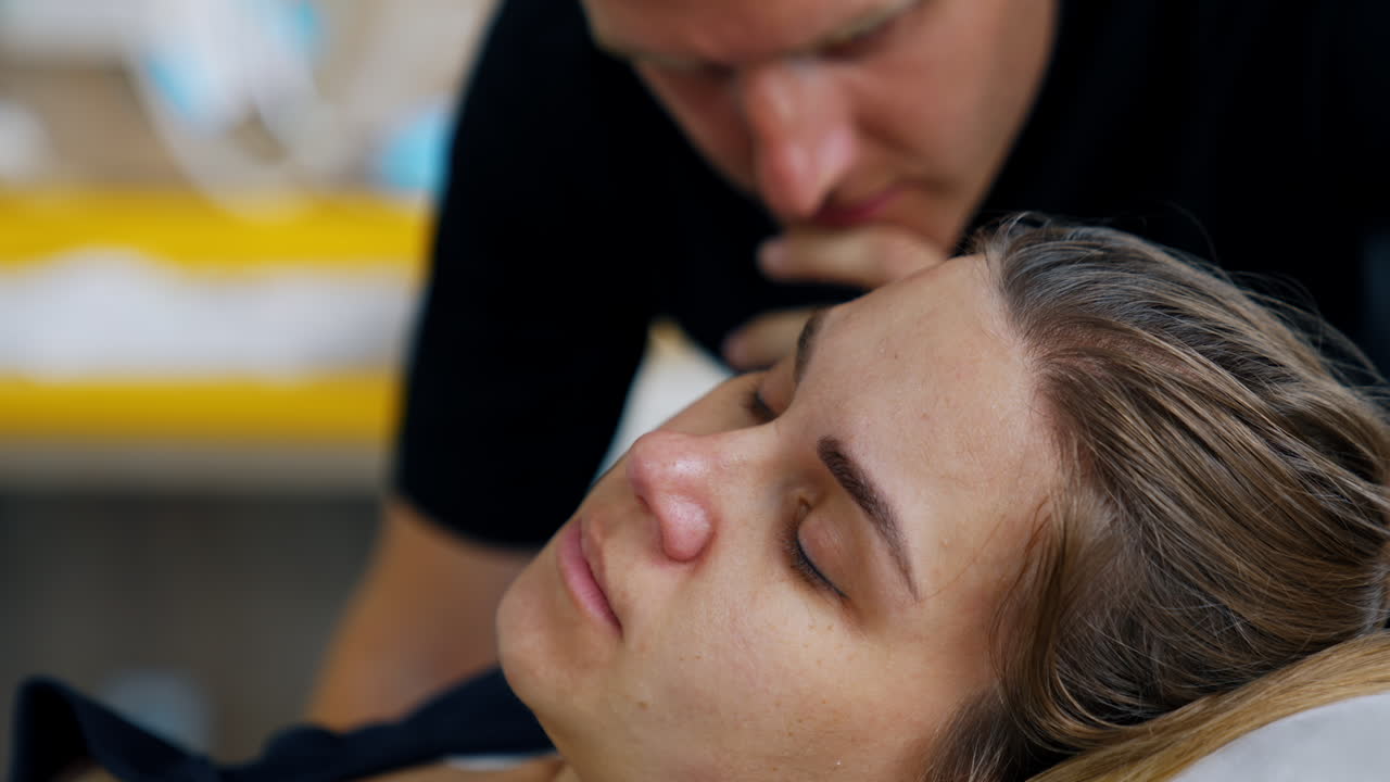 Woman resting in the pauses between the contractions. Worried husband stand watching close.