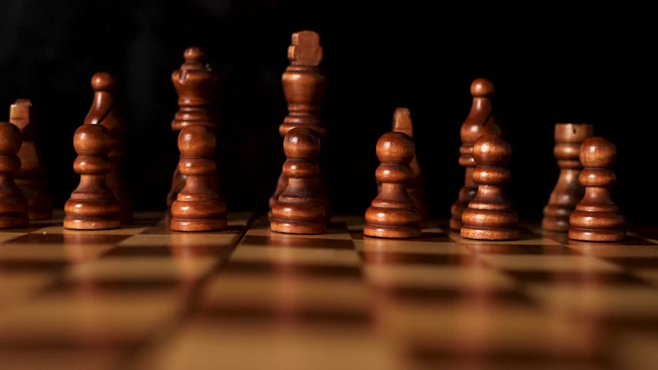 Low slide shot on the front brown row of a chess board