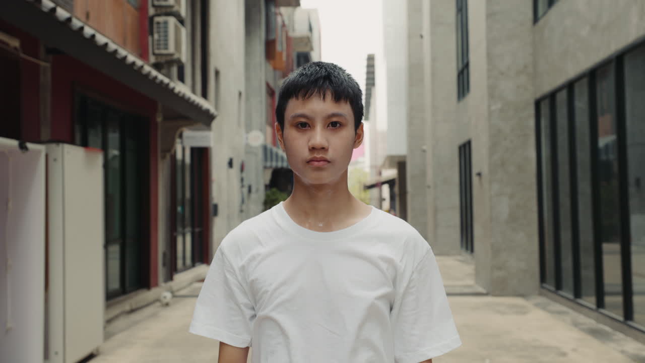 Portrait of a young person in an urban alley