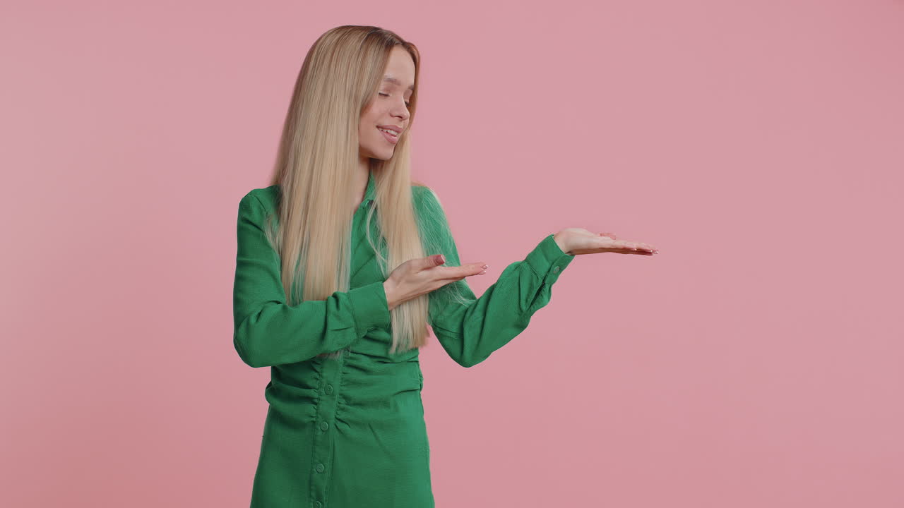 Young woman showing thumbs up pointing at right on blank space place for your advertisement logo