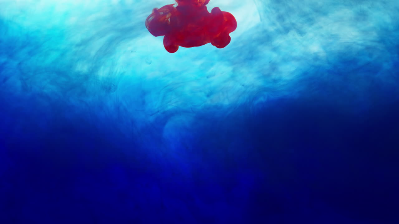 빨간색과 파란색 페인트 또는 염료가 색 배경에 물에 떨어지면 회전하는 다채로운 연기 배경을 만니다.