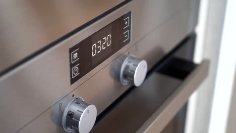 close-up of a modern stainless steel oven control panel