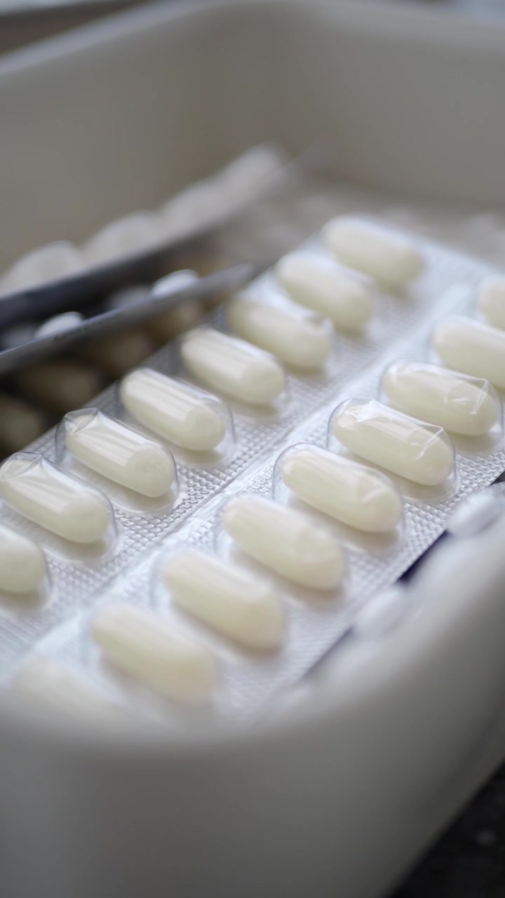 Close-up View of White Capsules in Blister Packs