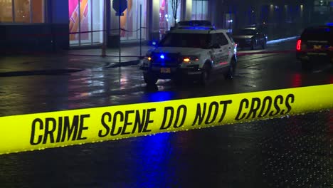 crime scene do no cross tape with cop car