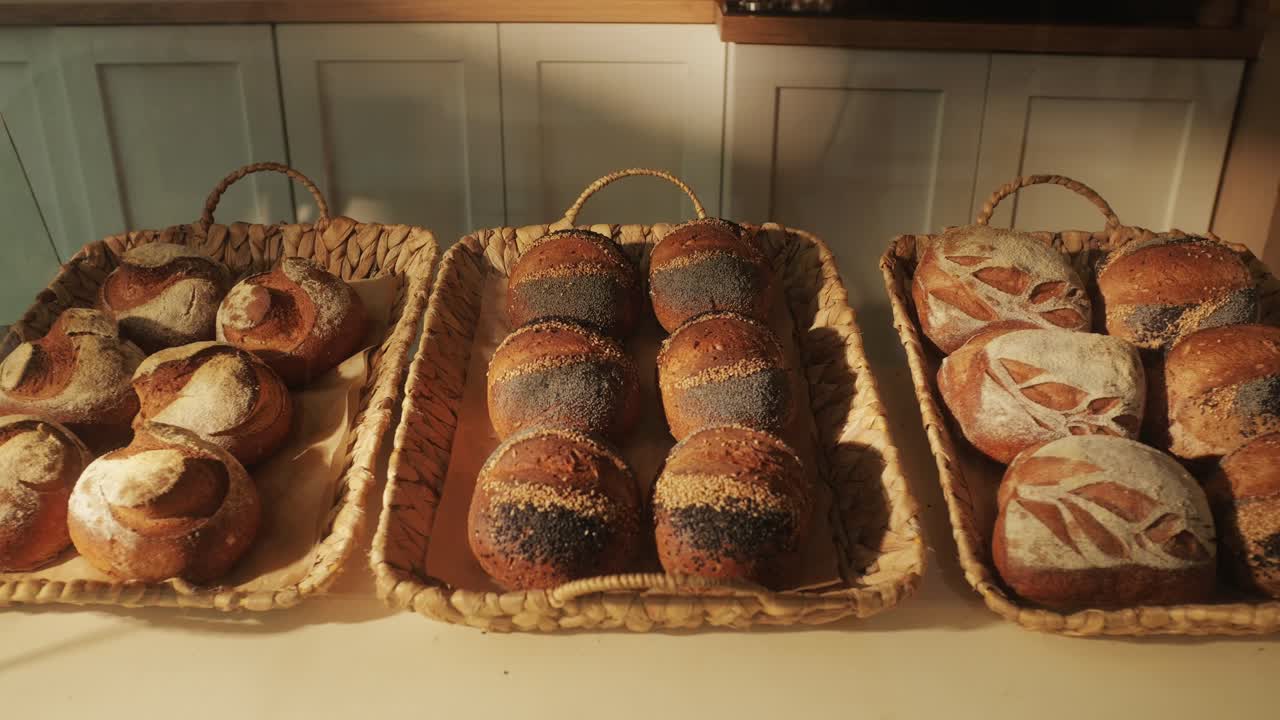 Fresh artesian bread on bakery shop close-up. Bread with black poppy garnish on top and white flour on top. Artisan bread is making by skill bakers using natural and high-quality ingredients. Food with health and flavour benefits.