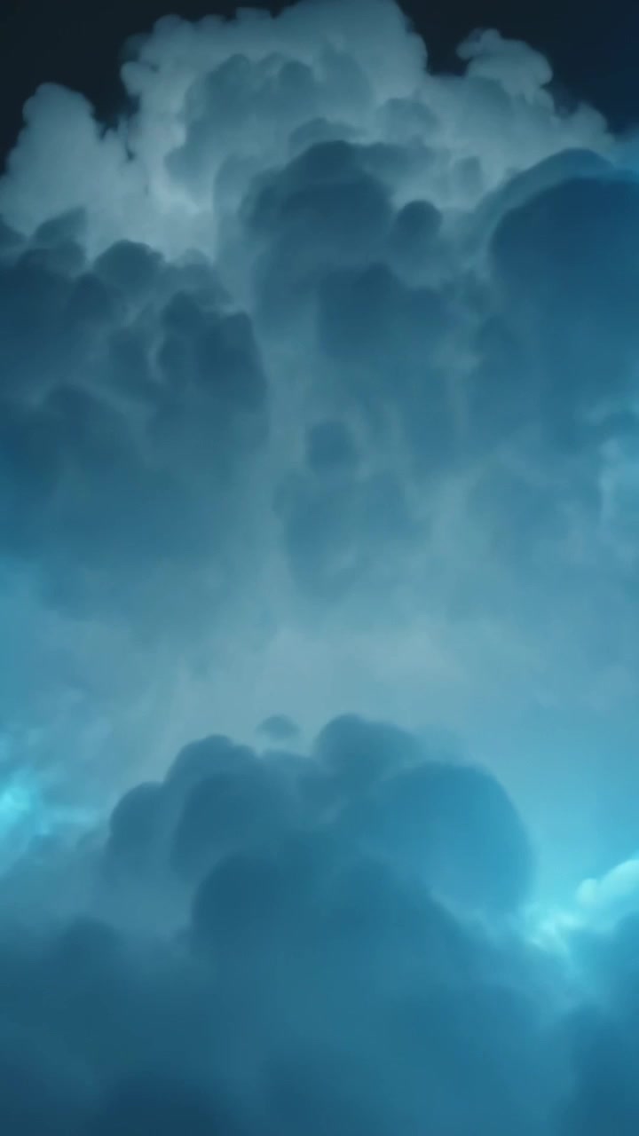 Vertical video: Beam starting lower right, blue light cutting tall cloud at dusk, showing layers