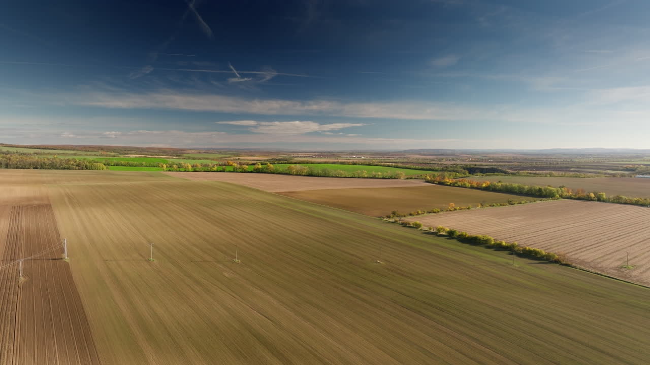 High-altitude drone shot of vast patchwork fields and rural countryside in South Moravia, Czech Republic