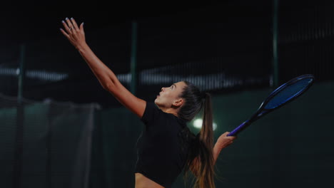 woman playing tennis at night