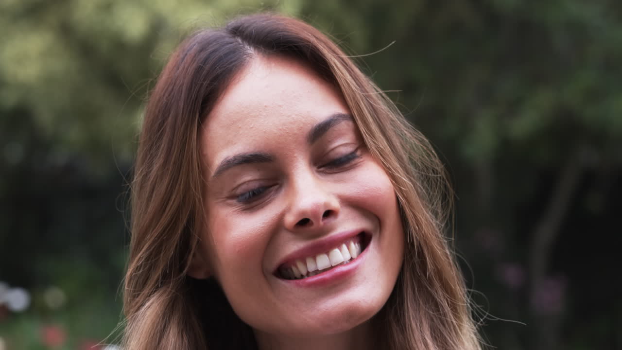 Portrait of smiling woman enjoying outdoor garden