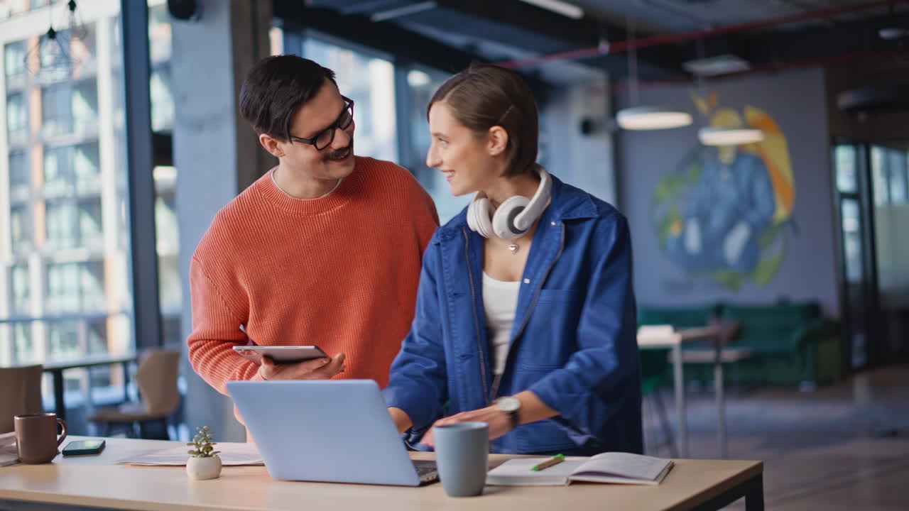 Professional coworkers planning investment strategy looking laptop at workspace