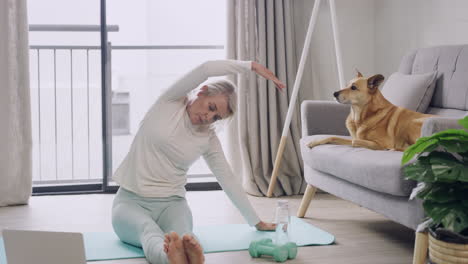 woman practicing yoga while watching online video