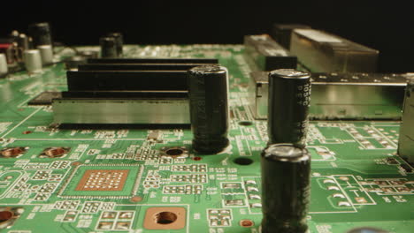 beautiful macro of a printed circuit board with diodes, transistors and microchips in a dark studio