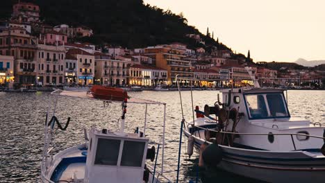 sunset over a picturesque greek harbor with fishing boats