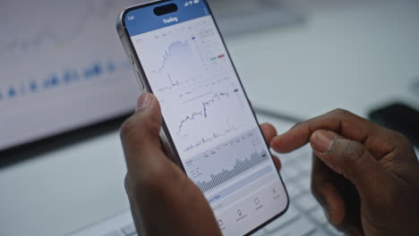 person using a mobile trading app