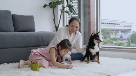 single asian mother taking care of daughter and dog at home