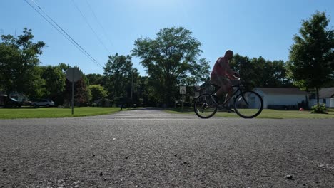 adult man exercising on bike in his neighborhood