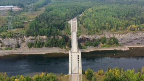 drone captures aerial view of peace river suspension bridge in british columbia