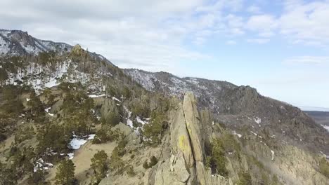 snowy mountain scenery with rock formations and frozen lake