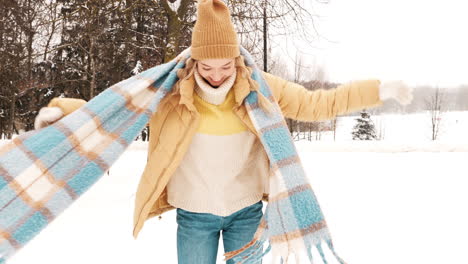 woman enjoying a snowy day in a park