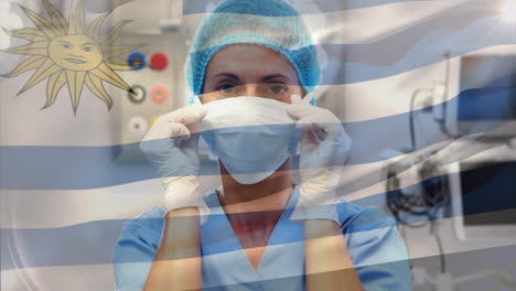 animation of flag of uruguay waving over female surgeon in operating theatre