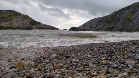 slow motion sea waves crashing in on small bay in mumbles uk