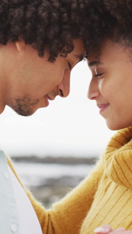 biracial couple shares a tender moment outdoor