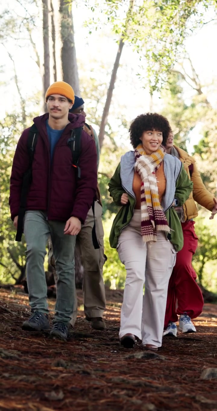 Group of Diverse Friends Hiking Together in a Forest