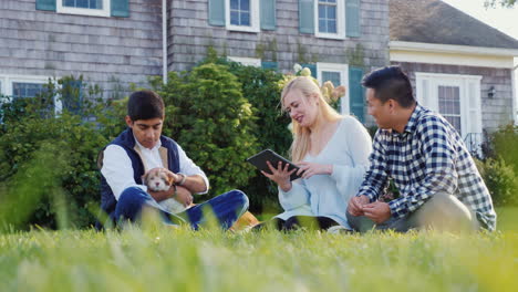 men and woman with tablet and puppy