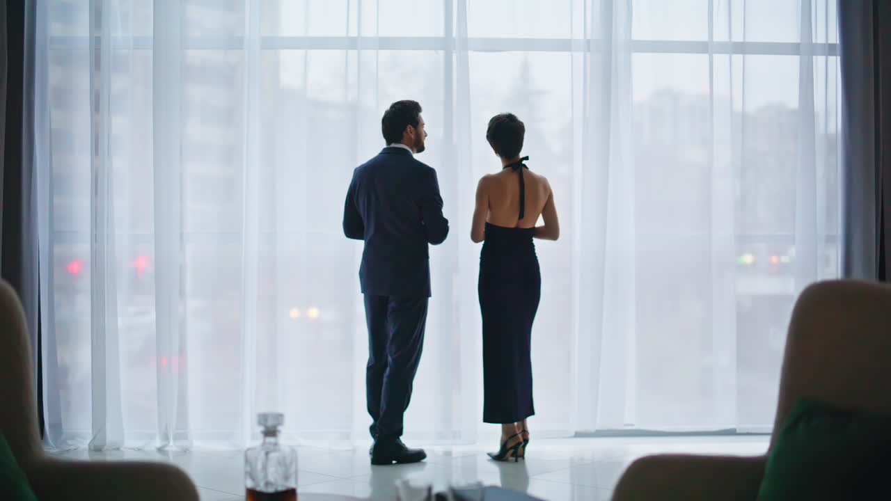 Romantic couple talking window cityscape back view. Love people conversation
