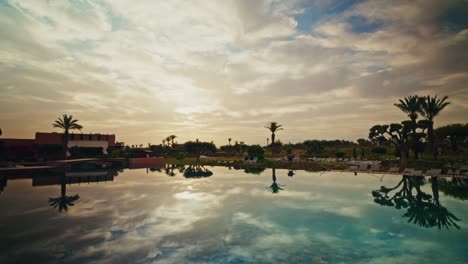 panoramic view of the exteriors of the fairmont royal palm resort in marrakesh at sunrise. luxury hotel. refined exterior design. view of the outdoor swimming pools.